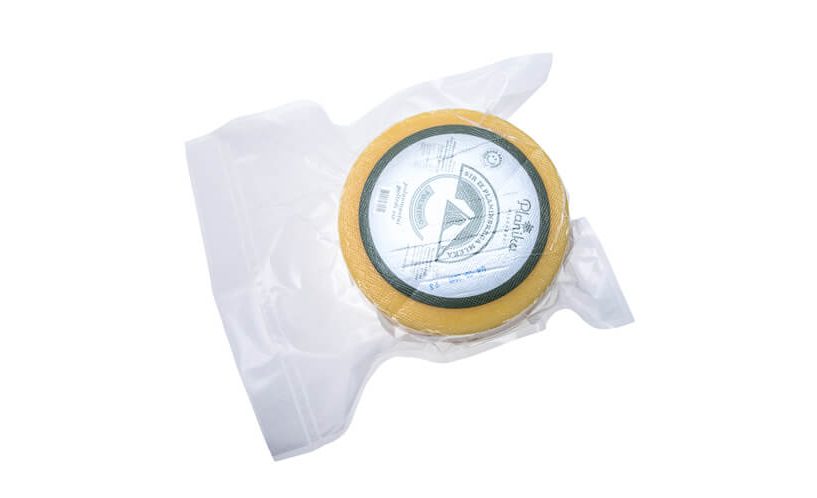 Vacuum packed wheel of cheese for sales and transport.