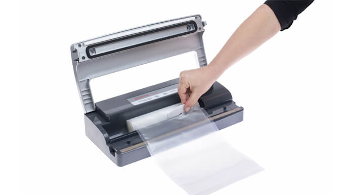 Foil roll compartment inside a vacuum sealer